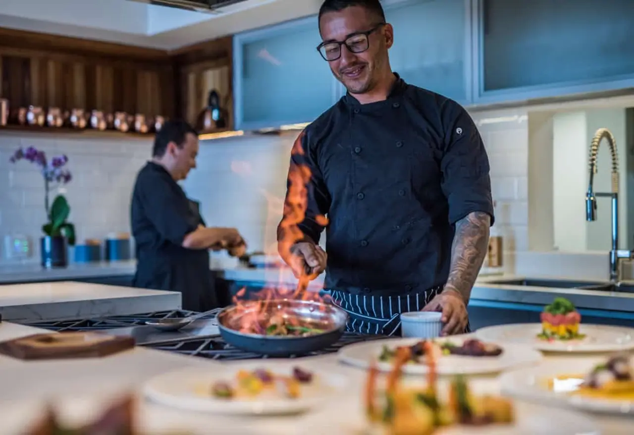 Private chef cooking in a modern villa kitchen